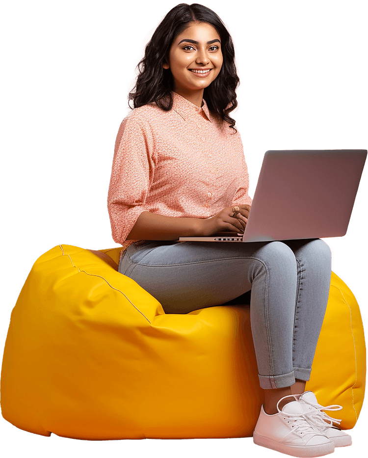 Professional woman in coral sweater sitting with laptop, smiling